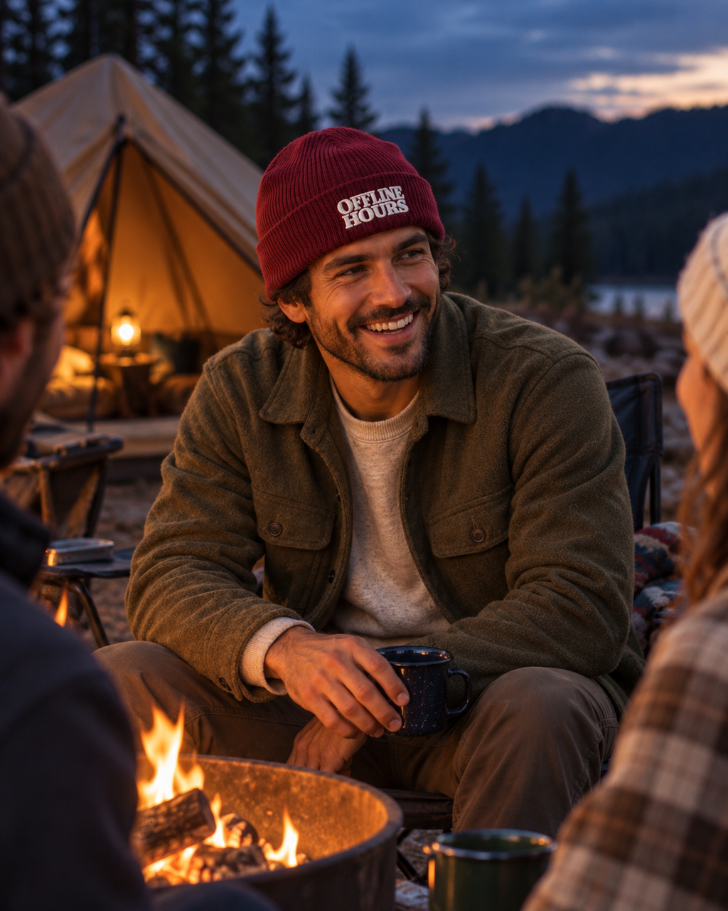 Offline Hours Organic Ribbed Beanie — Burgundy — lifestyle wide dusk campfire scene laughing with friends